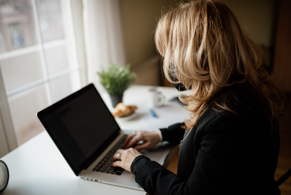 Small business owner reviewing hosting plan details on a laptop before choosing website hosting and email services